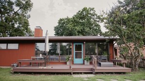 A modern house with a deck, a blue door, and a large window. - Relax & Recharge: Mid-Century Modern Home with Sauna in Spring Green (Spring Green)