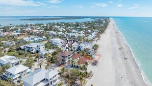 An aerial view of a coastal residential area with houses, a beach, and a clear sky. - Ready for Rentals- All New Kitchen- Stunning Interior (Captiva)