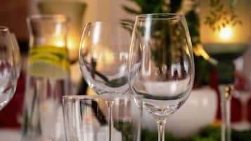 A table set with wine glasses, a fork, and a candle.