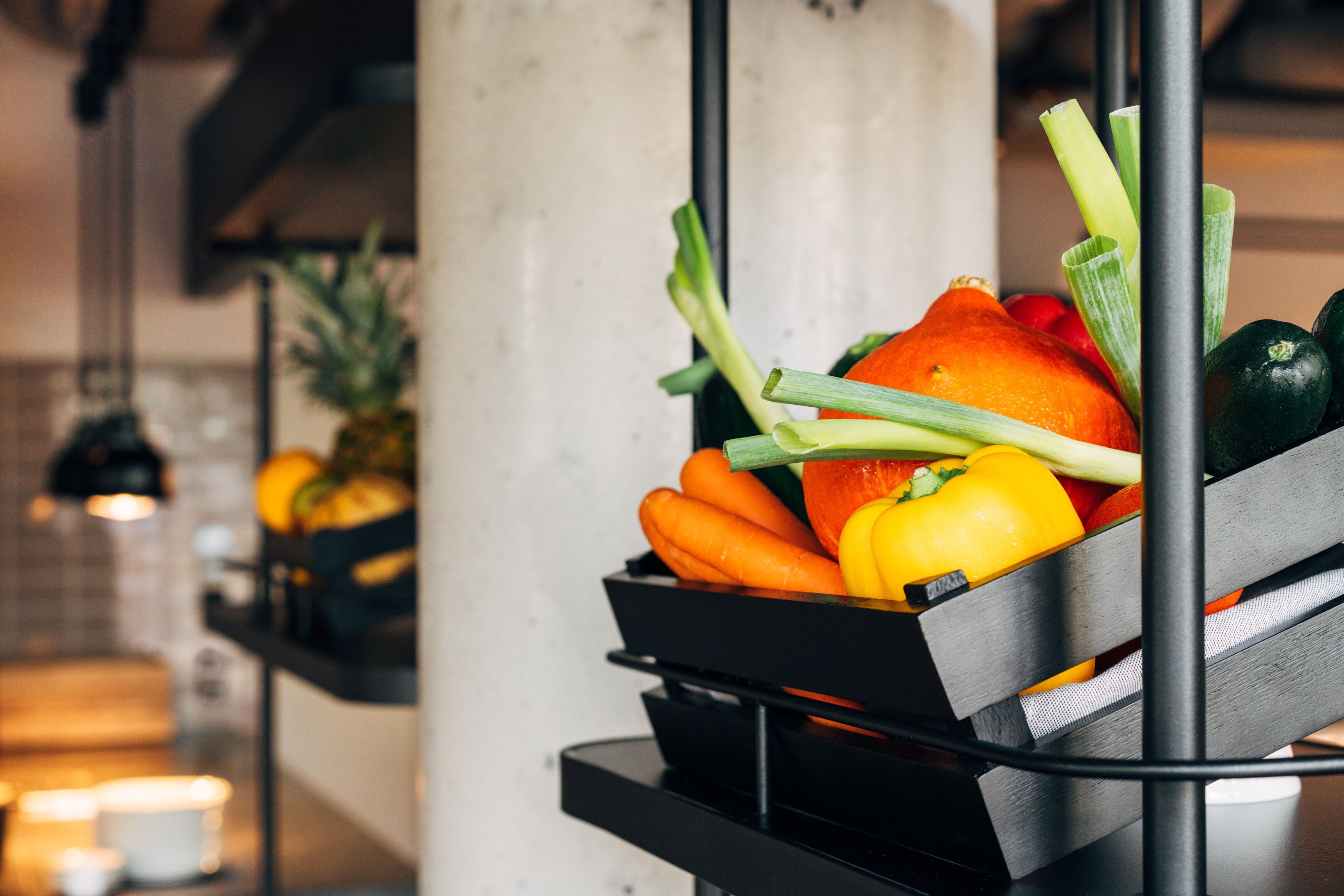A kitchen counter with a fruit and vegetable basket.
