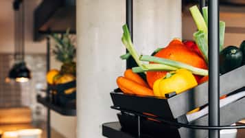 A kitchen counter with a fruit and vegetable basket.