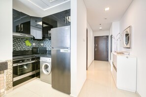 Exclusive Apartment | Private kitchen | Coffee/tea maker, electric kettle, cleaning supplies, dining tables