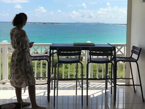 Enjoy breathtaking sea views from this balcony, complete with a table and two chairs.