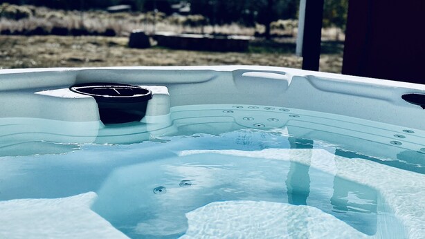 A hot tub with a clear view of the surrounding landscape.
