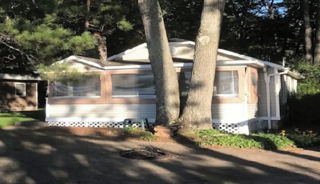 Front view of cabin showing screened in porch.  
