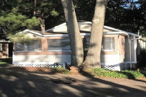 Front view of cabin showing screened in porch.
