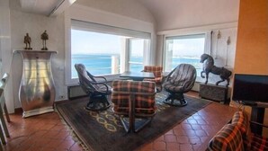 A room with a view of the sea, a fireplace, and a television. - Villa Alco in Roses with beautiful sea views AV-68 (Rosas / Roses)