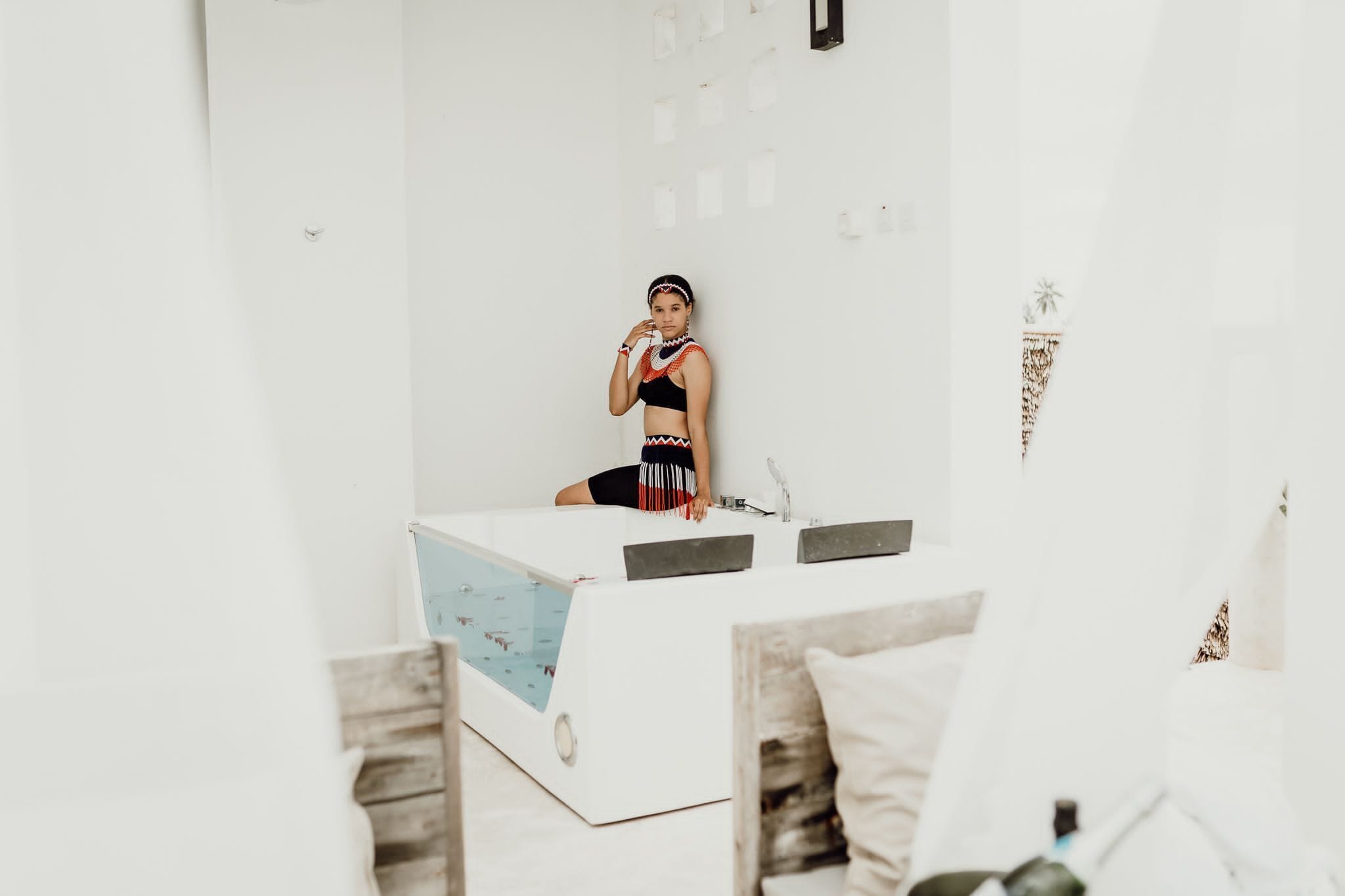 A modern, minimalist room with a white color scheme, a small pool table, and a simple, clean design.