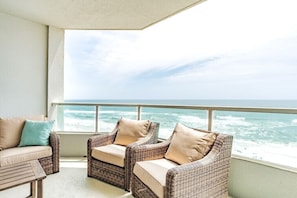Relax on the balcony with ocean views, featuring two sofas and a comfortable seating area.