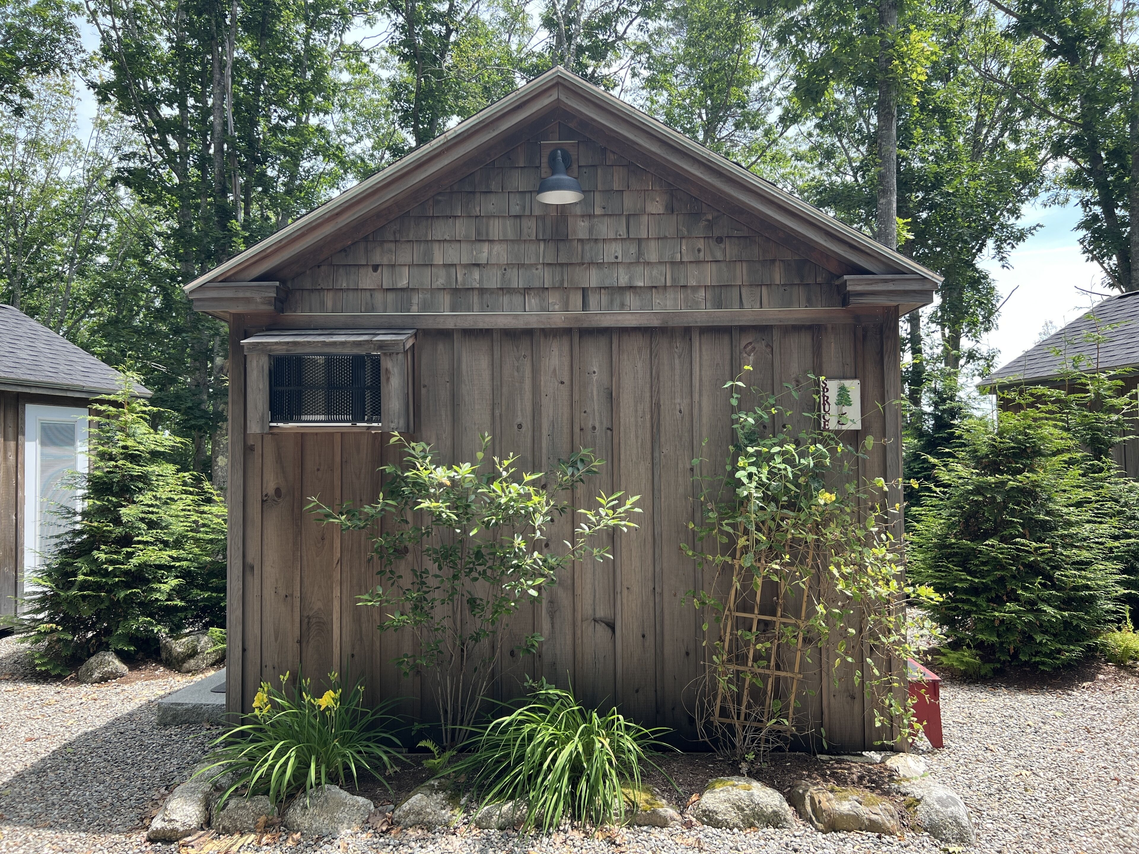 A wooden shed with a slanted roof, a small window, and a sign that reads "BUDDY'S".