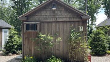A wooden shed with a slanted roof, a small window, and a sign that reads "BUDDY'S".