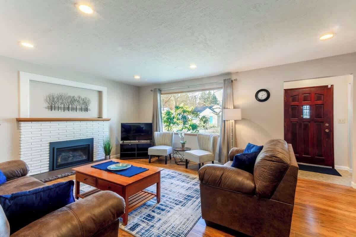 A living room with a fireplace, television, and comfortable seating.