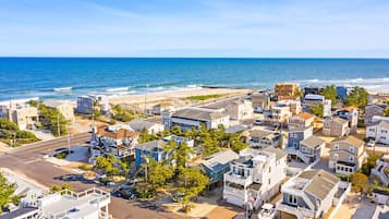 A coastal residential area with houses, a beach, and ocean views.