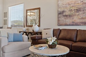 Relax in this stylish living room with a sofa, leather couch, and coffee table.