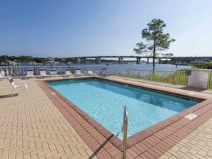 A swimming pool with a view of a bridge and water body. - Penthouse Views & Coastal Ease: 2 BR w/ King Beds (Okaloosa Island)