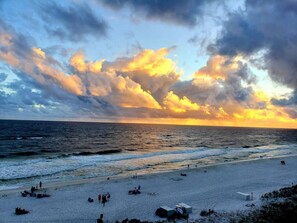 A beach with people and a sunset. - Penthouse Views & Coastal Ease: 2 BR w/ King Beds (Okaloosa Island)