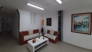 A modern living room with a sofa, coffee table, and artwork on the wall. - 3G1-2 APARTAMENTO EN CARTAGENA (Cartagena)