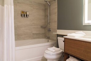 Bathtub, hair dryer, towels, shampoo