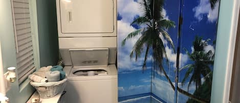 Convenient laundry facilities include a washer, dryer, and sink with a soap dispenser.