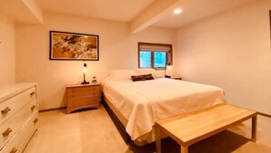 A bedroom with a bed, bedside tables, a bench, a dresser, and a window. - EAT, DRINK, PLAY & RELAX in Windham (Windham)