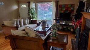A cozy living room with a sofa, coffee table, and fireplace.