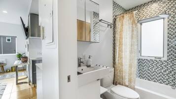 Combined shower/bathtub, towels, soap, toilet paper