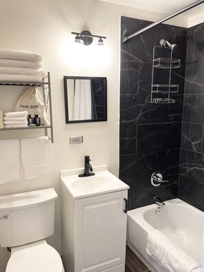 Combined shower/tub, hair dryer, towels, soap