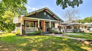 A two-story house with a front porch, brick exterior, and a well-maintained lawn. - NEW! Centrally Located Charlotte Home by Amtrak! (Charlotte)