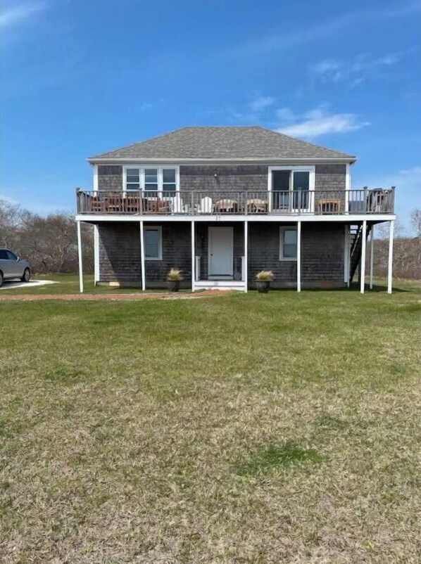 A two-story house with a balcony, a front porch, and a garage.