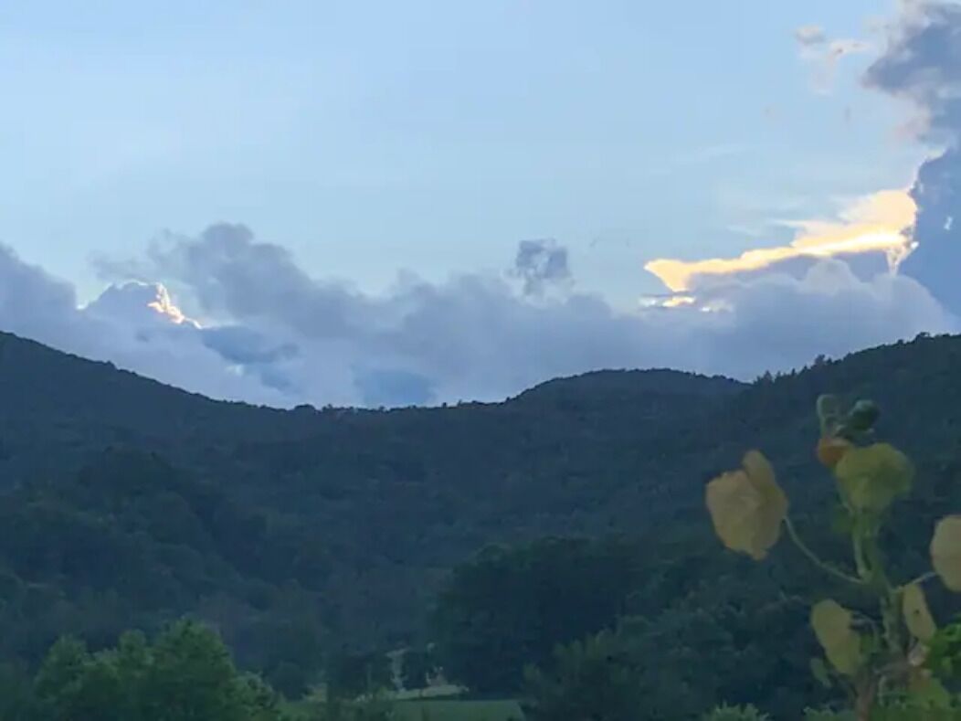 A mountainous landscape with a clear sky and some clouds.