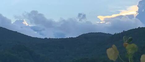 A mountainous landscape with a clear sky and some clouds.