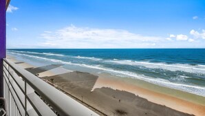 A beach view from a balcony with a clear sky. - Serene Oceanfront Getaway: 1BR with Private Balcony at Wyndham Oceanwalk (Daytona Beach)