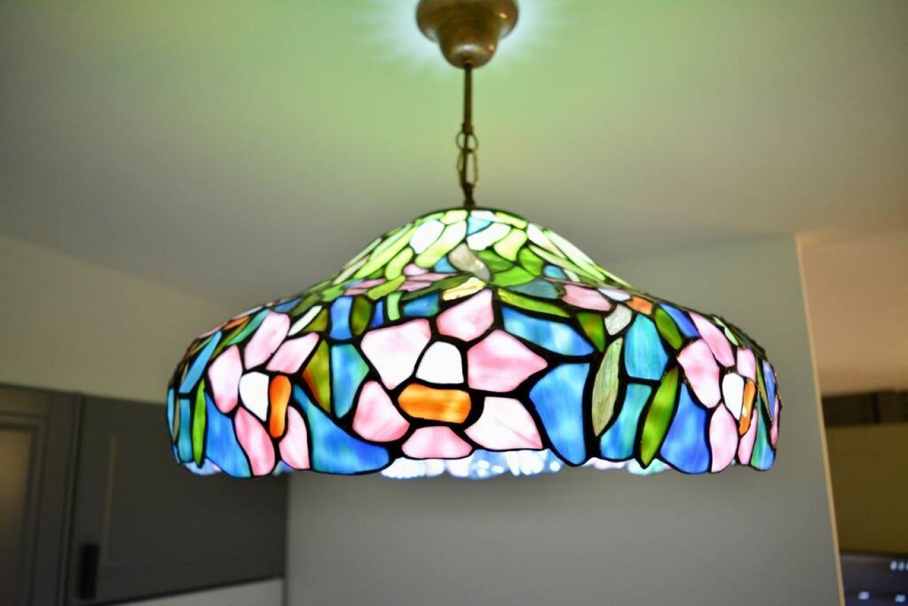 A stained glass chandelier with a floral pattern.
