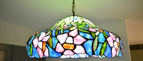A stained glass chandelier with a floral pattern.