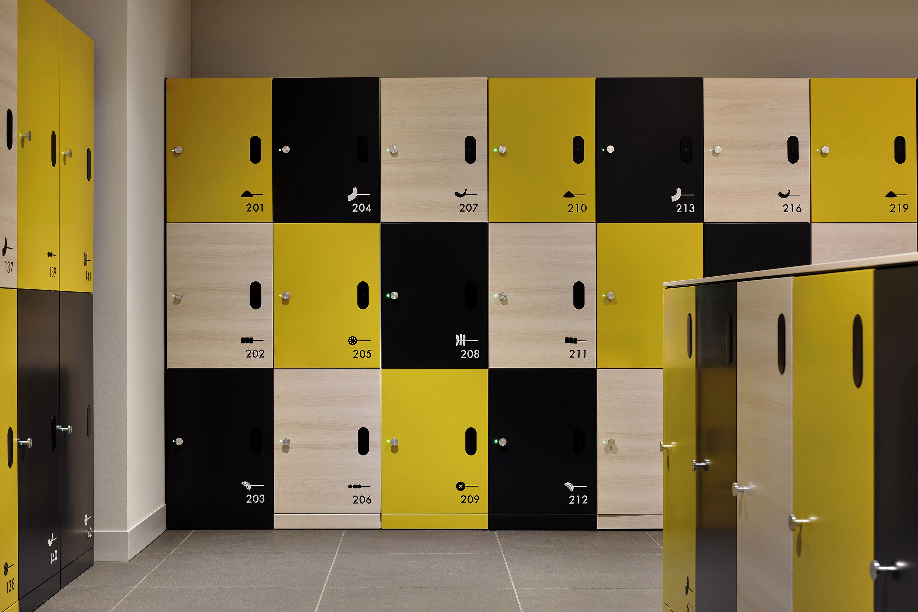 A row of lockers with numbers and symbols indicating different storage compartments.