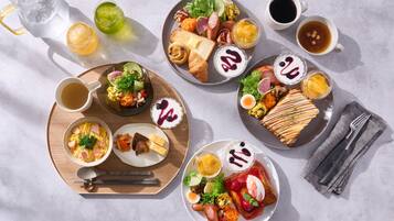 A table with various breakfast items including eggs, toast, and fruit.