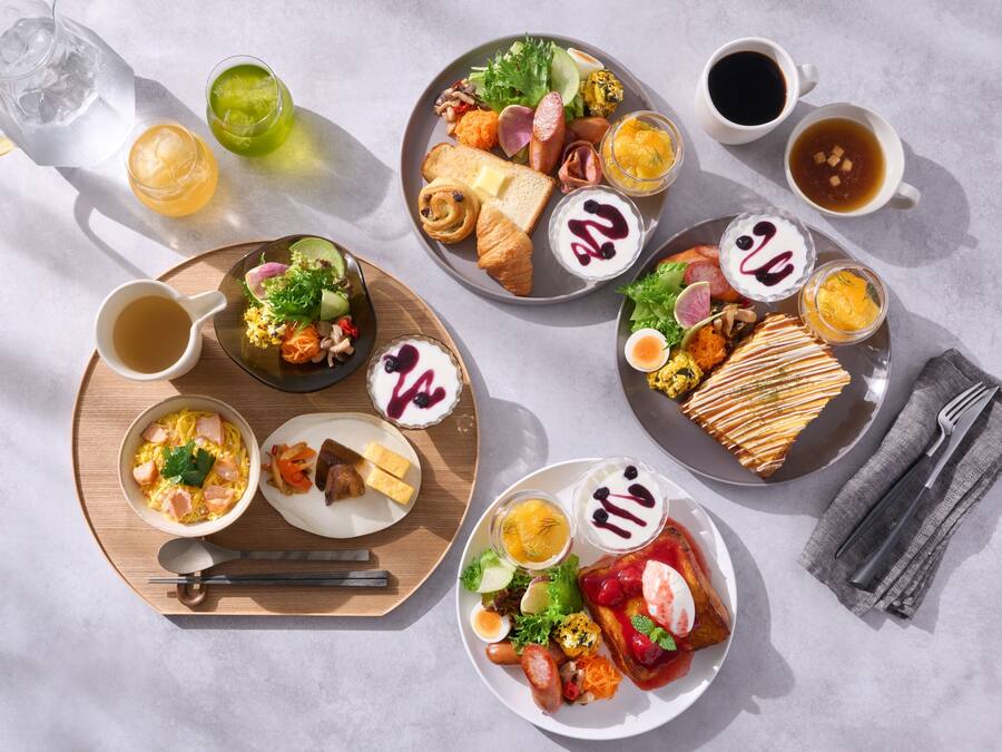 A table with various breakfast items including eggs, toast, and fruit.