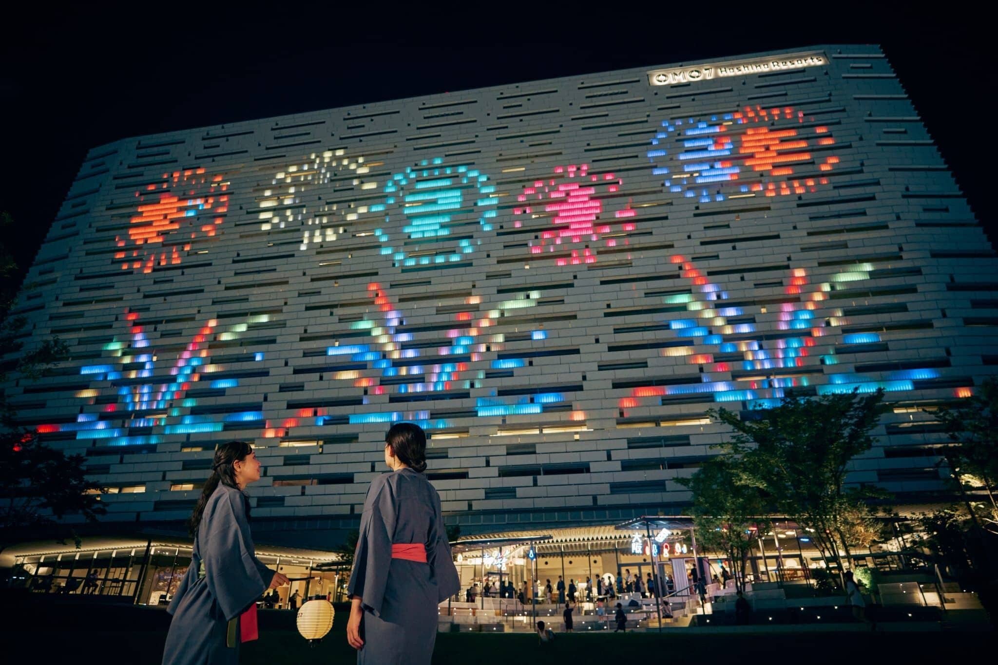 A modern building with a unique facade featuring illuminated patterns.