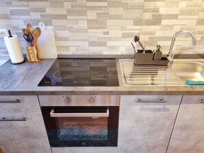Fridge, oven, toaster, dining tables