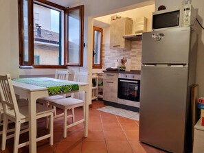 Fridge, oven, toaster, dining tables