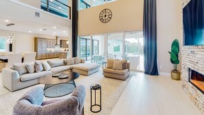 Ein geräumiges Wohnzimmer mit einer großen Eckcouch, einem Couchtisch und einem Kamin.