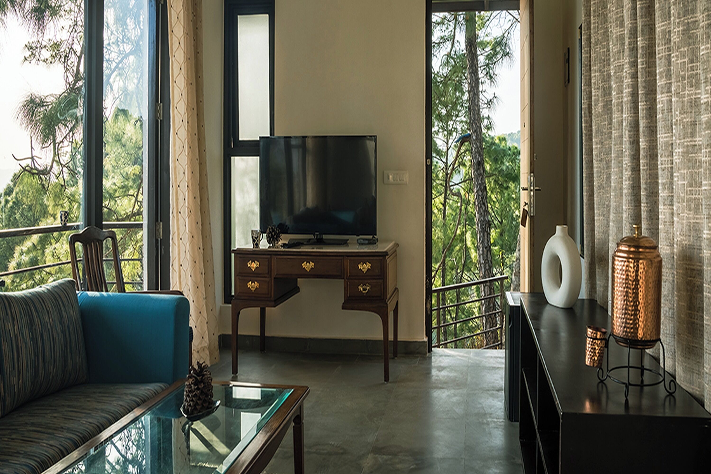 A modern living room with a sofa, coffee table, TV, and decorative items.