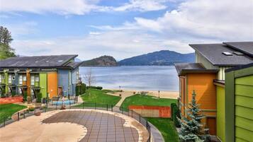 Stunning views of a serene lake and distant island from this modern home's outdoor space.