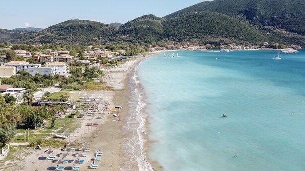 A coastal town with a beach, clear blue waters, and hills in the background. - Holiday Apartment 'Apostolos Apartment 2' Close to Beach with Sea View (Lefkada)