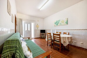 A dining area with a table, chairs, and a bench.