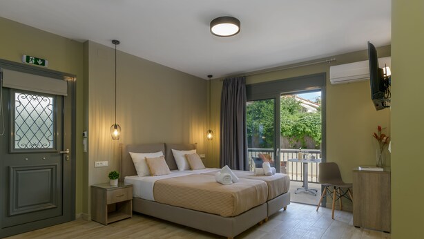 A hotel room with a large bed, bedside tables, a desk, and a view of the outdoors. - Casa De' Fiori Kefalonia★Studio 3 (Σκάλα)