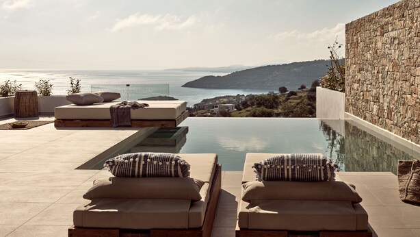 A poolside area with lounge chairs and a view of the sea. - The Sall Suites Complex A - Sea Views (Zakynthos)