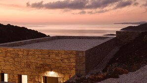 A stone building with a flat roof overlooking a body of water. - The Sall Suites Complex A - Sea Views (Zakynthos)