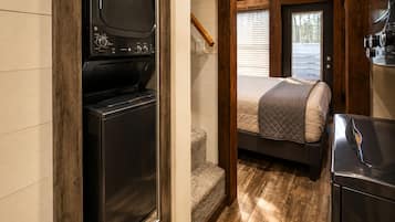 A compact kitchenette with a stove, oven, and microwave.
