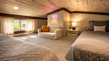 A hotel room with two beds, a sofa, a neon sign, a lamp, and a window with curtains.